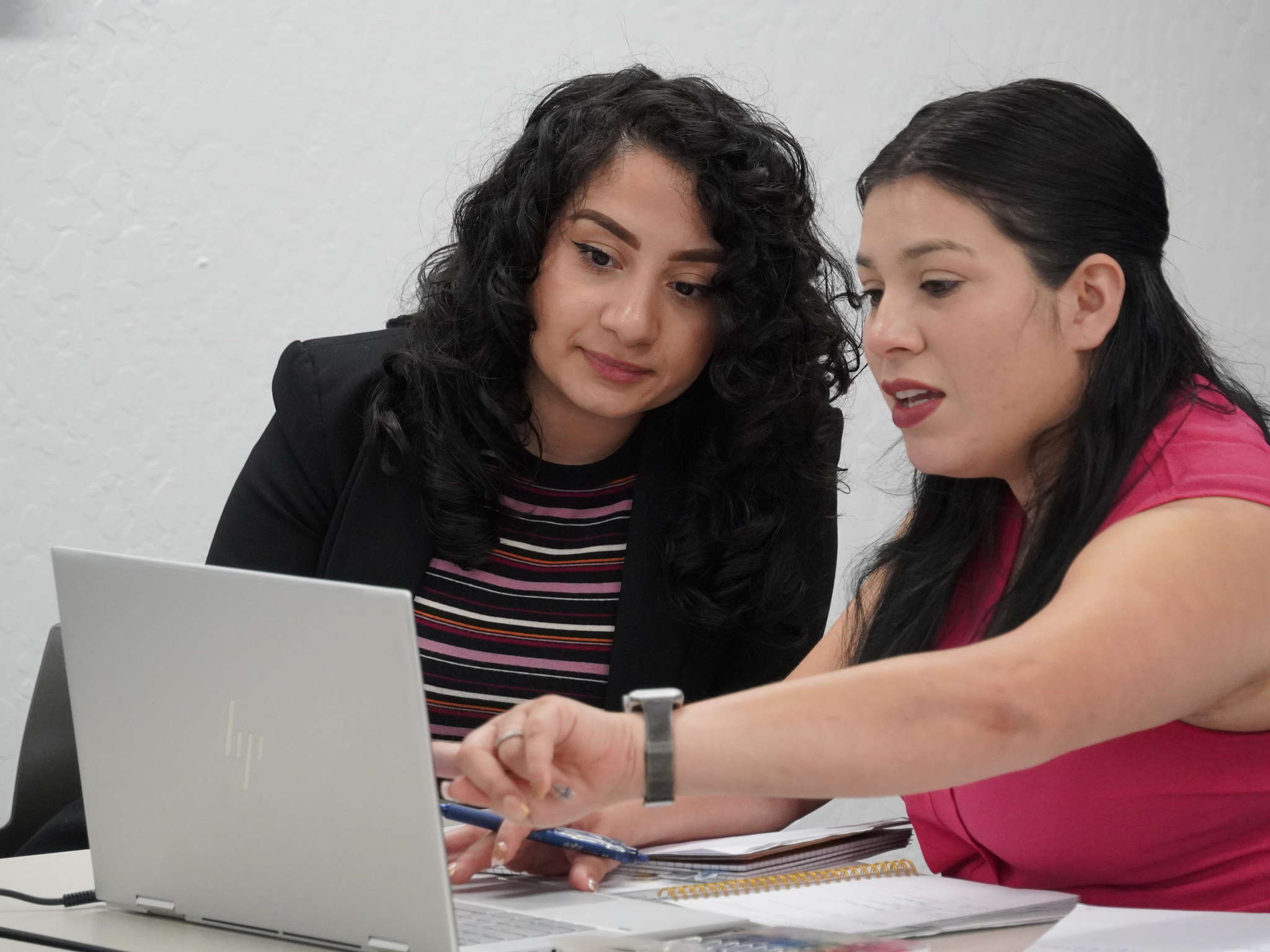 Students studying together over a laptop