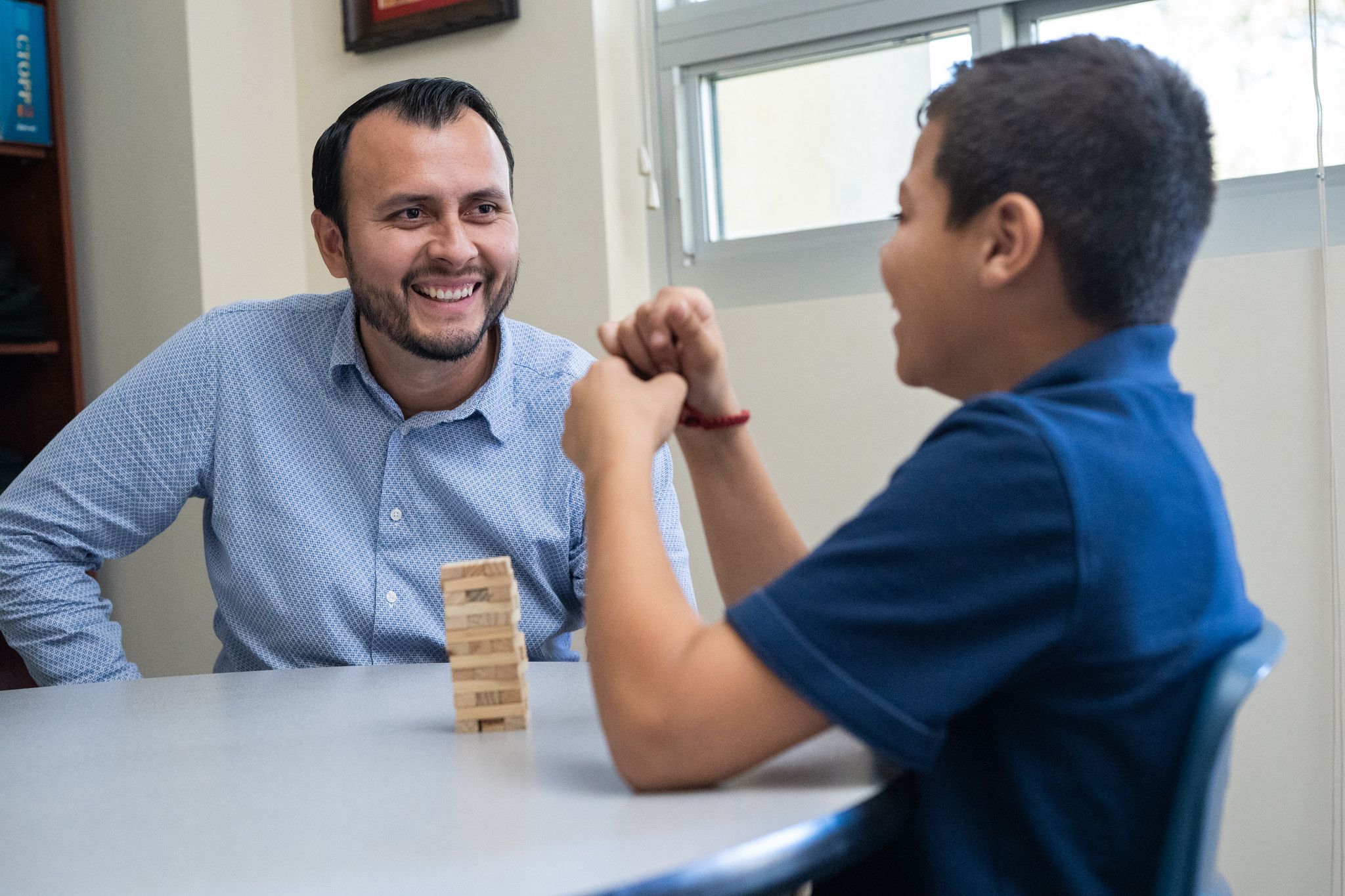 teacher with student at table