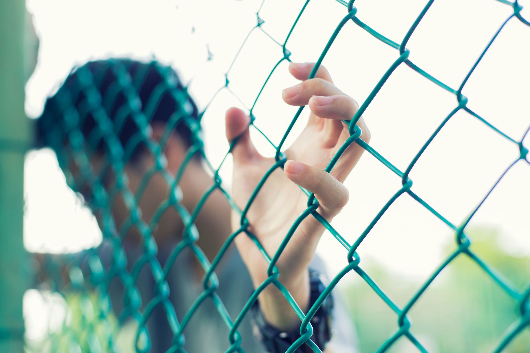 man behind a fence