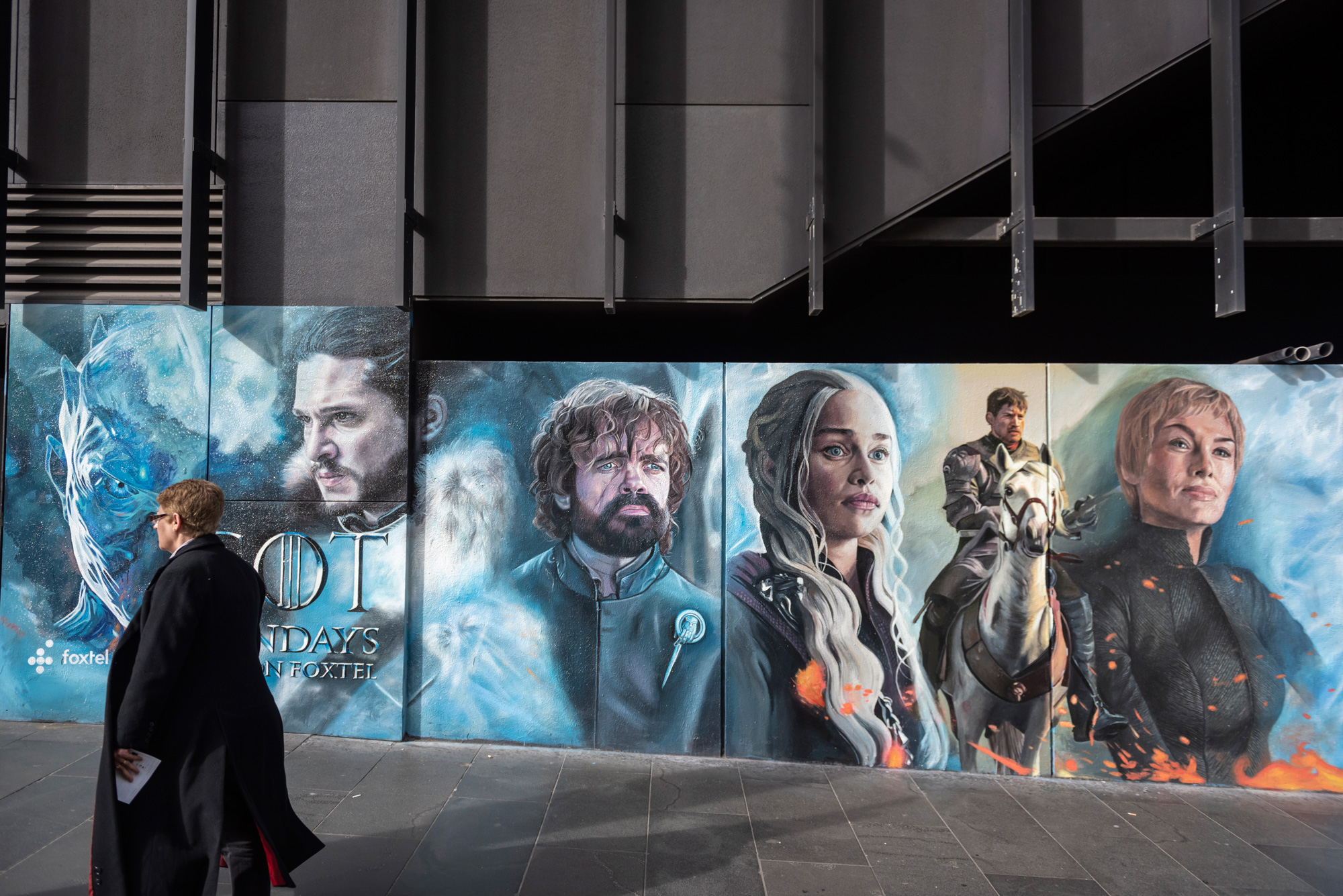 woman near game of thrones street mural