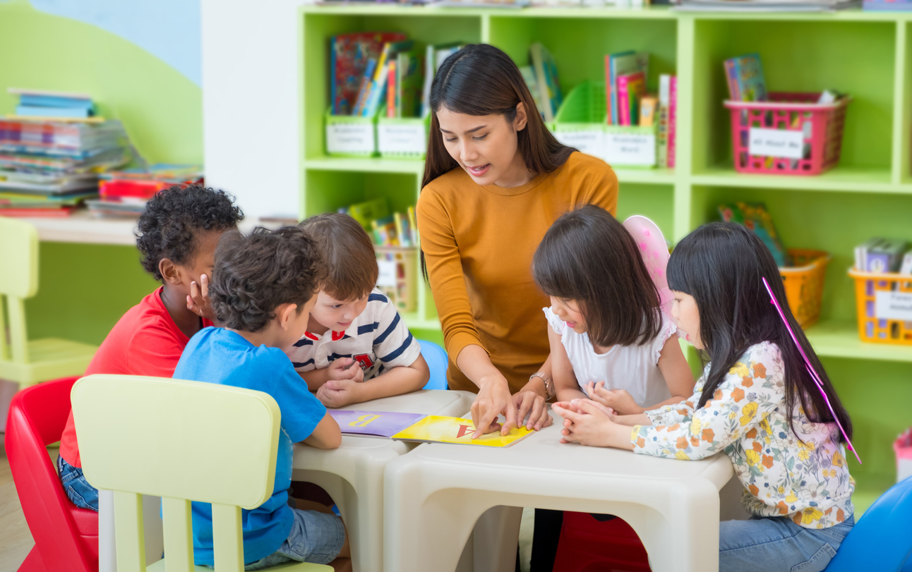 female teacher teaching group of children