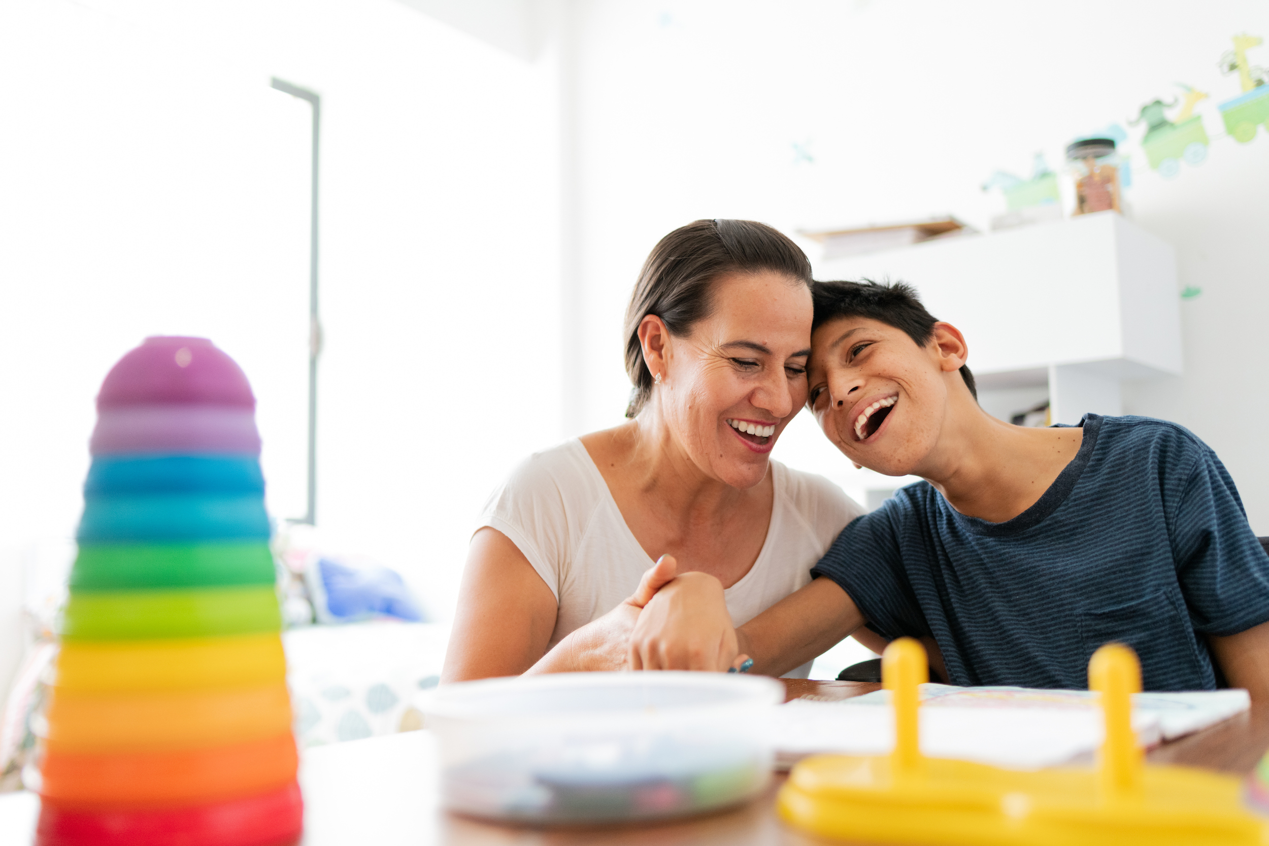 woman playing with boy with cerebral palsy