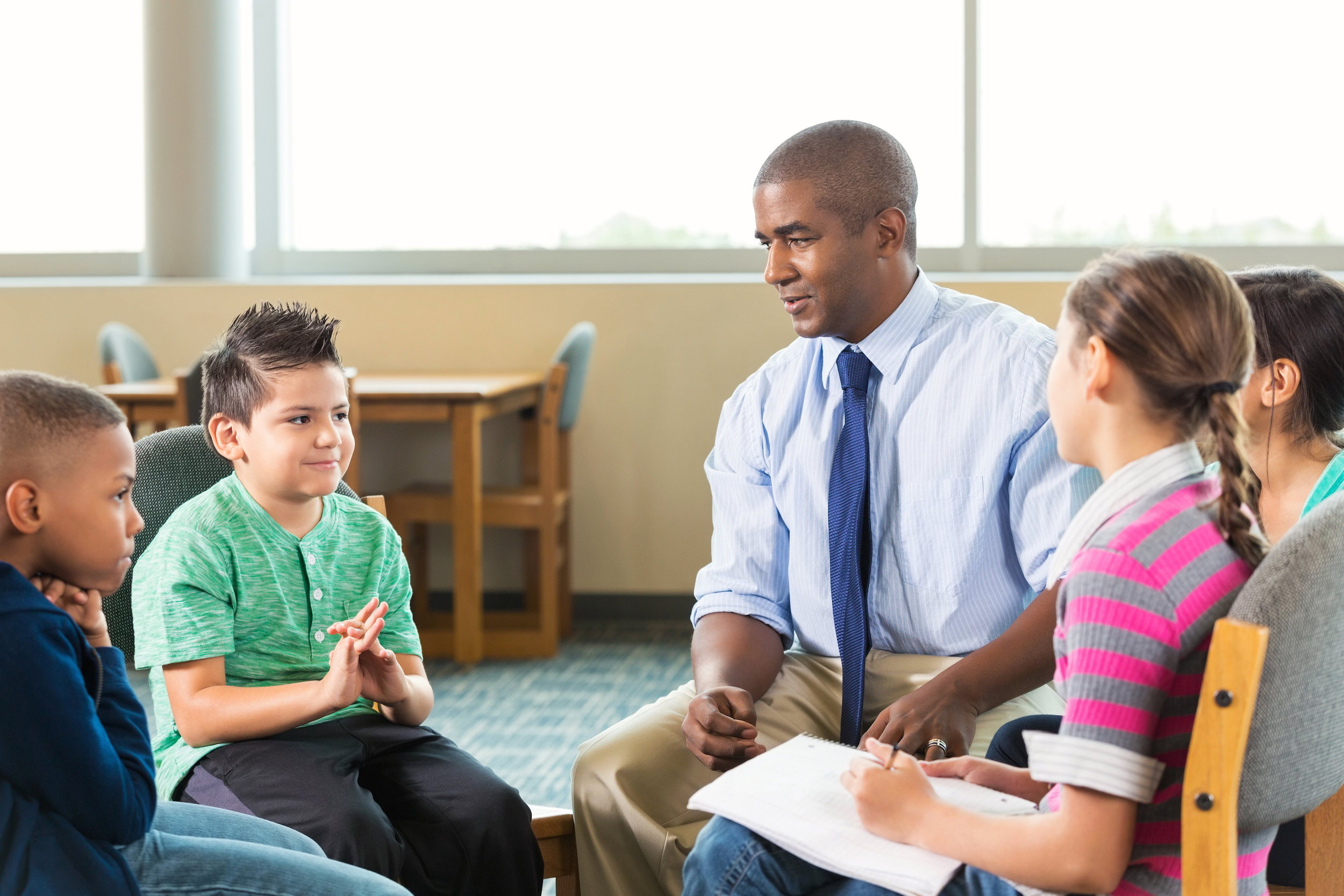 elementary students meeting with counselor