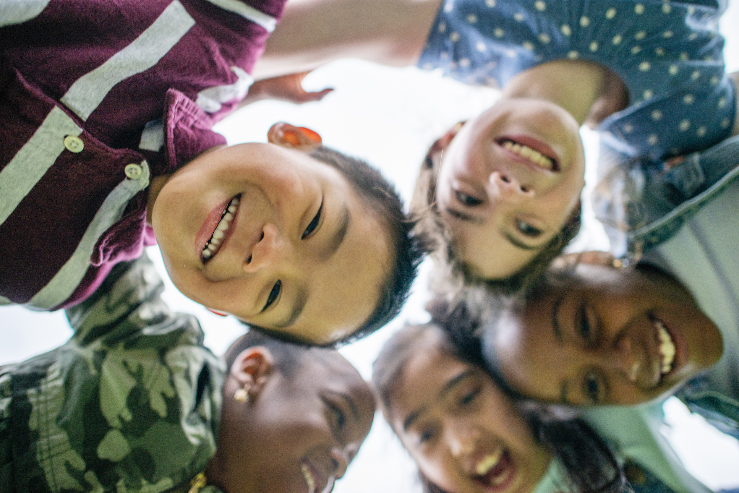 group of young children looking down from circle