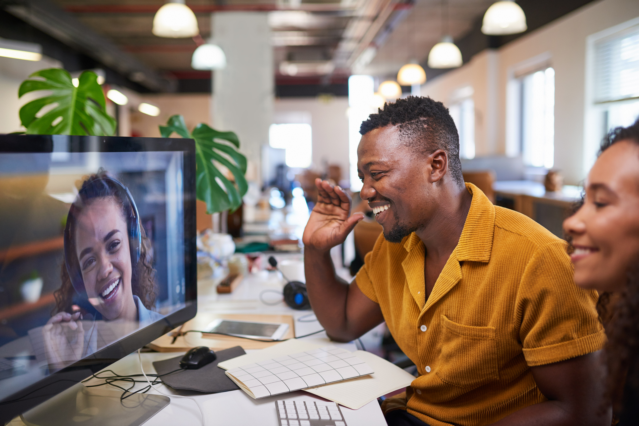 man talking to woman on computer screen