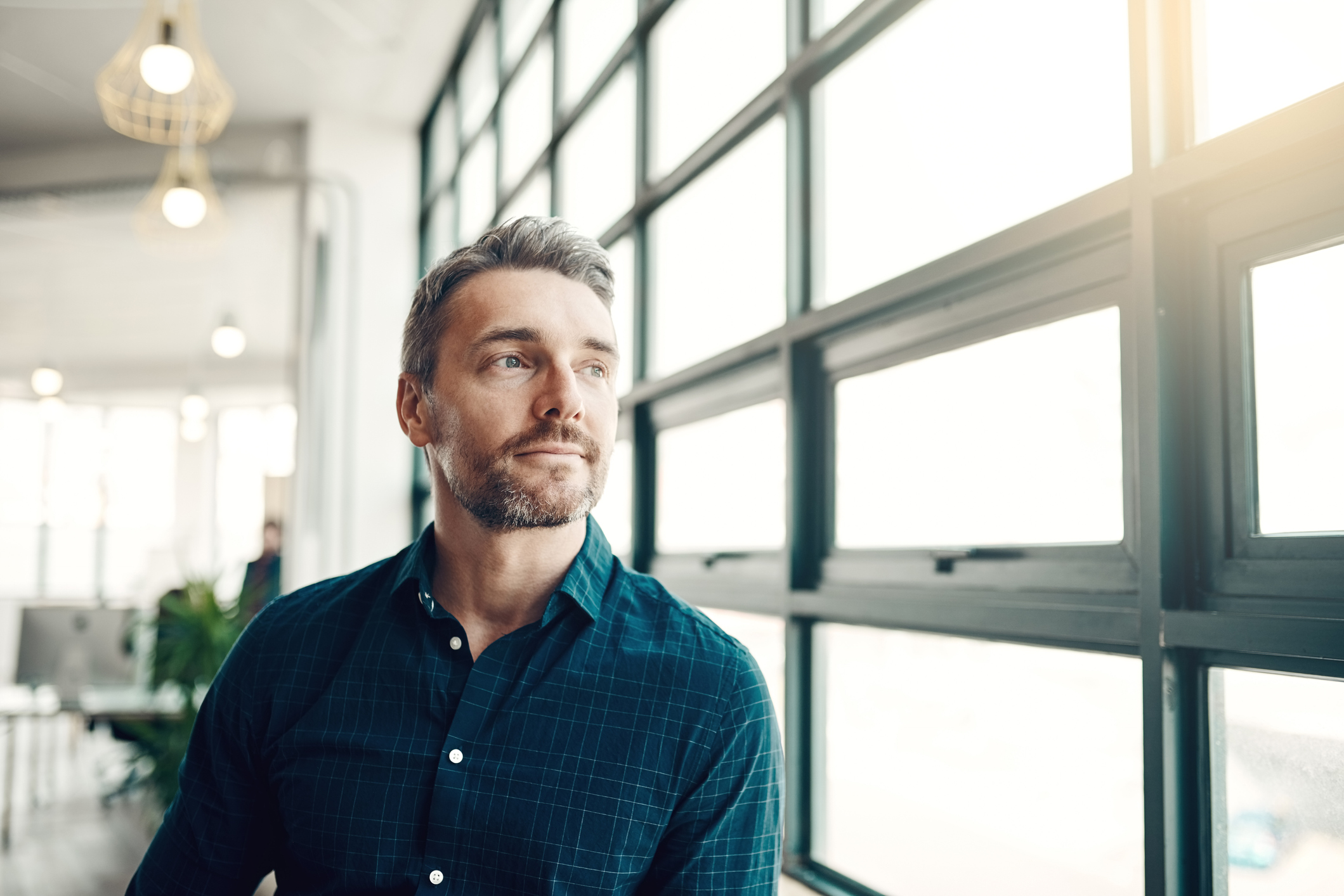 man looking out of window