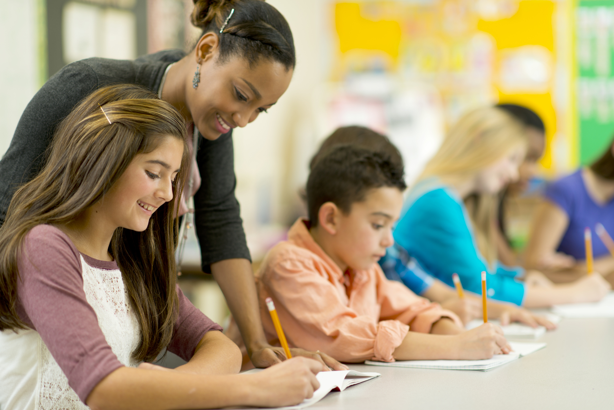 teacher helping middle school students