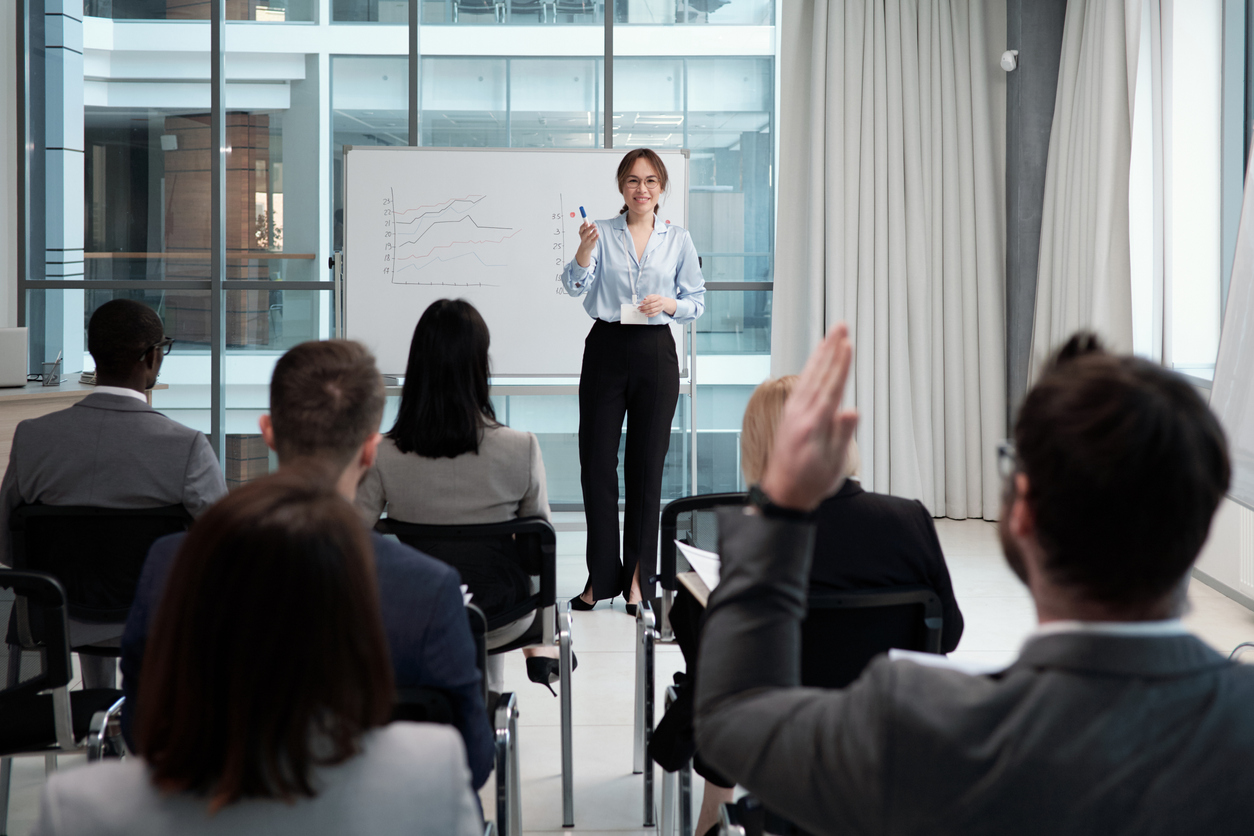 woman teaching in front of adult students