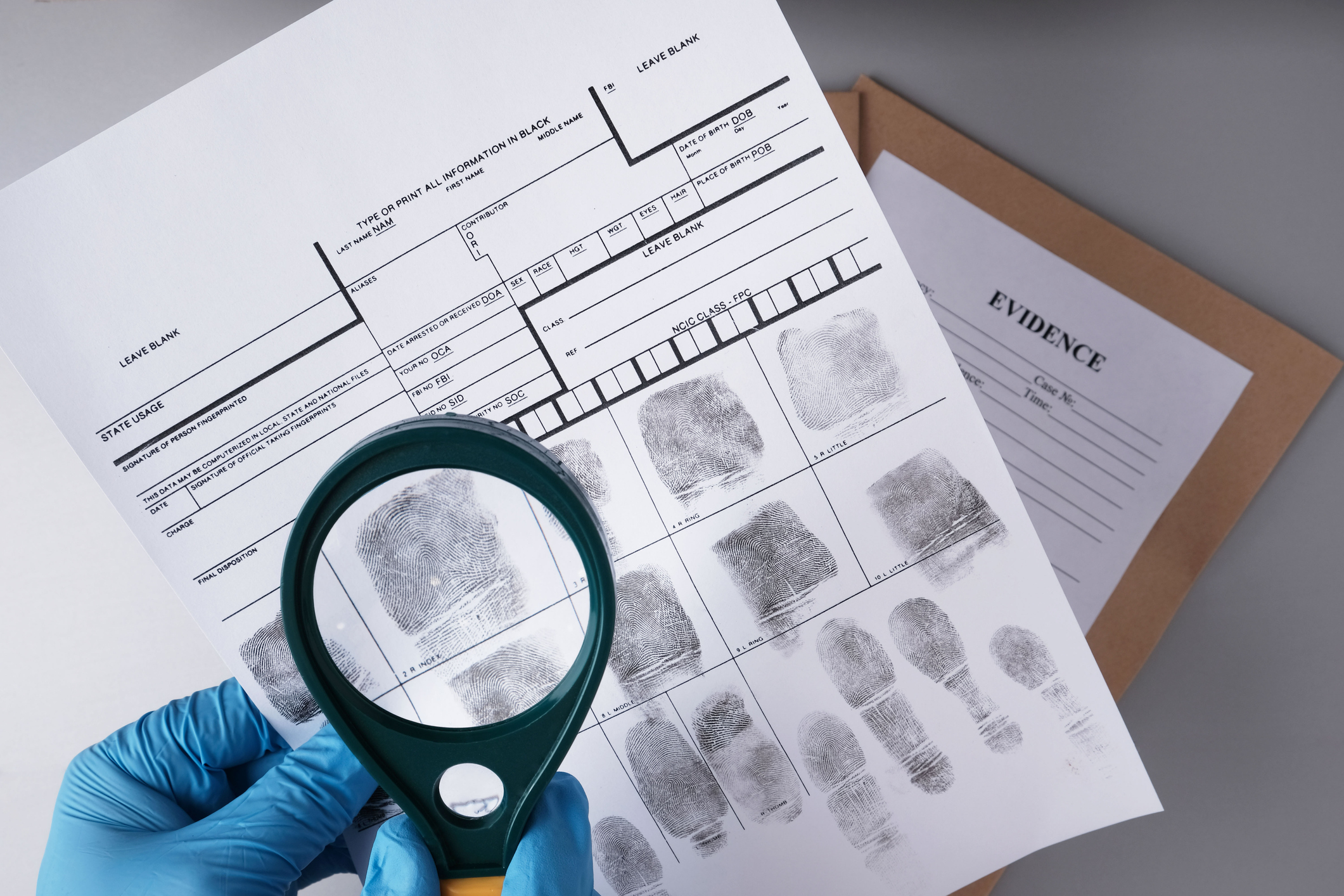 magnifying glass viewing fingerprints