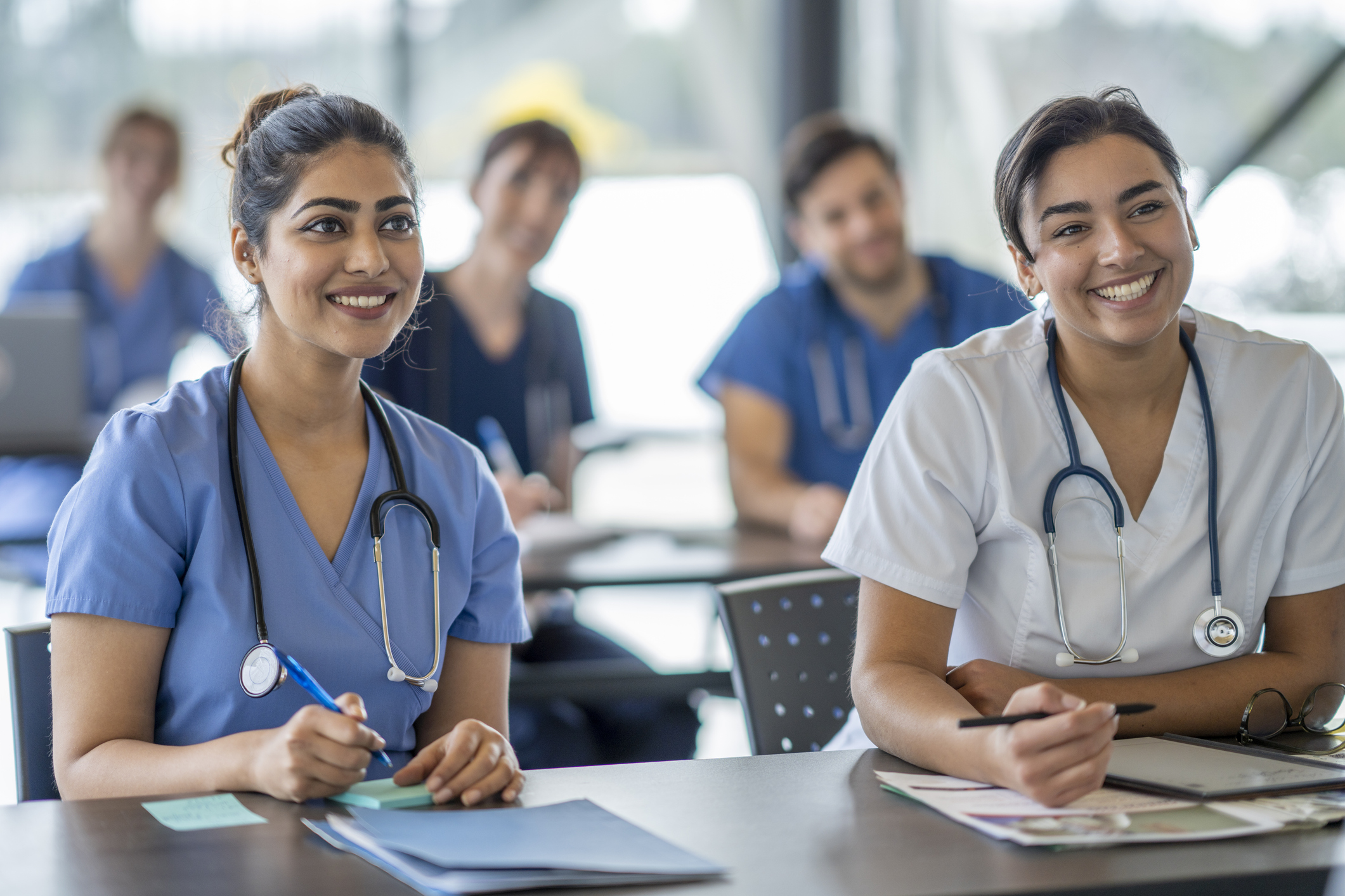 nurse sitting and listening to speaker