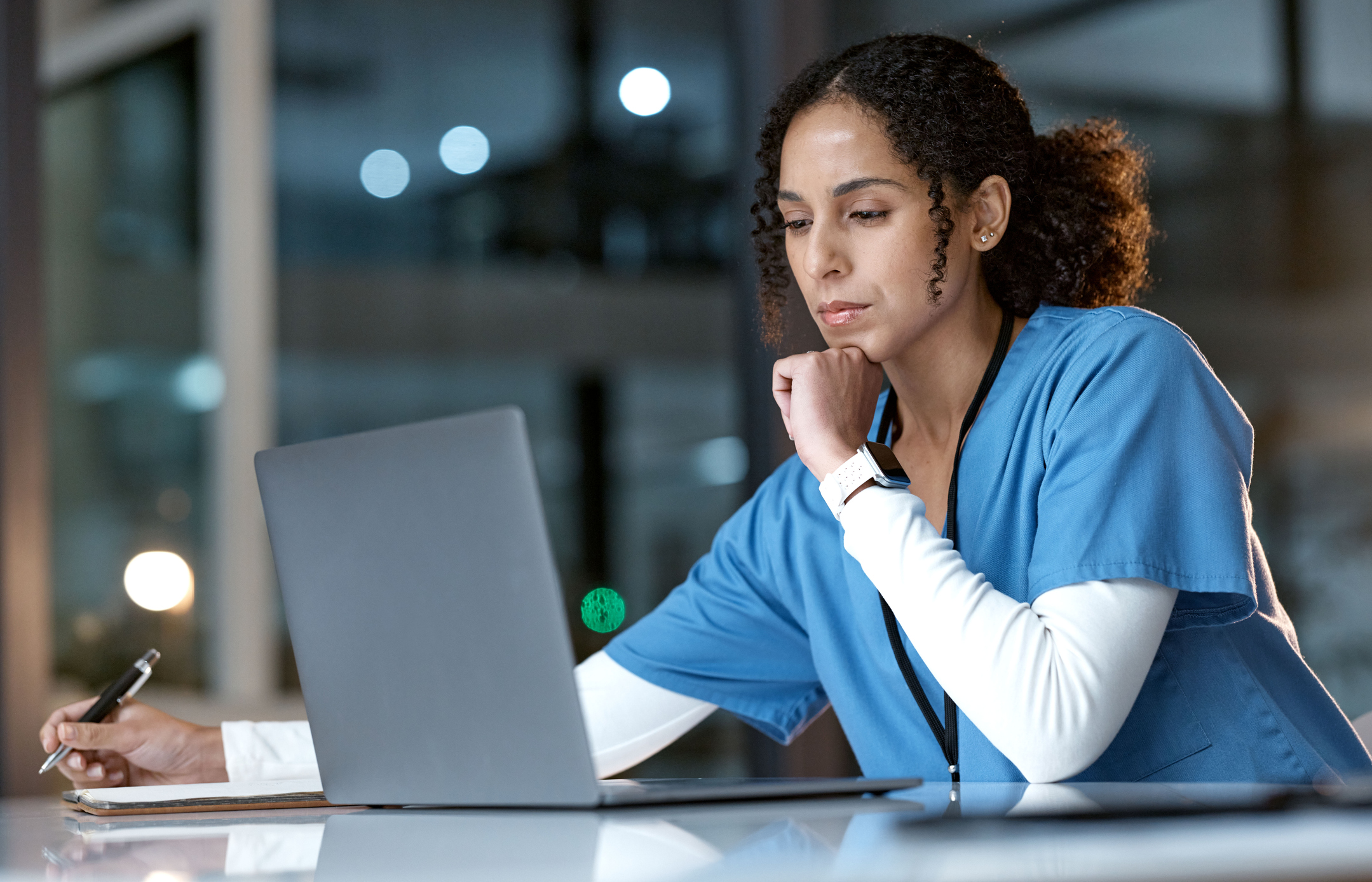 nurse looking at a laptop