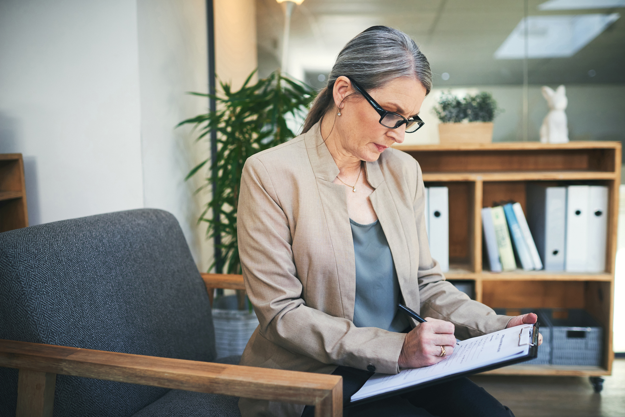 woman writing notes on a notepad