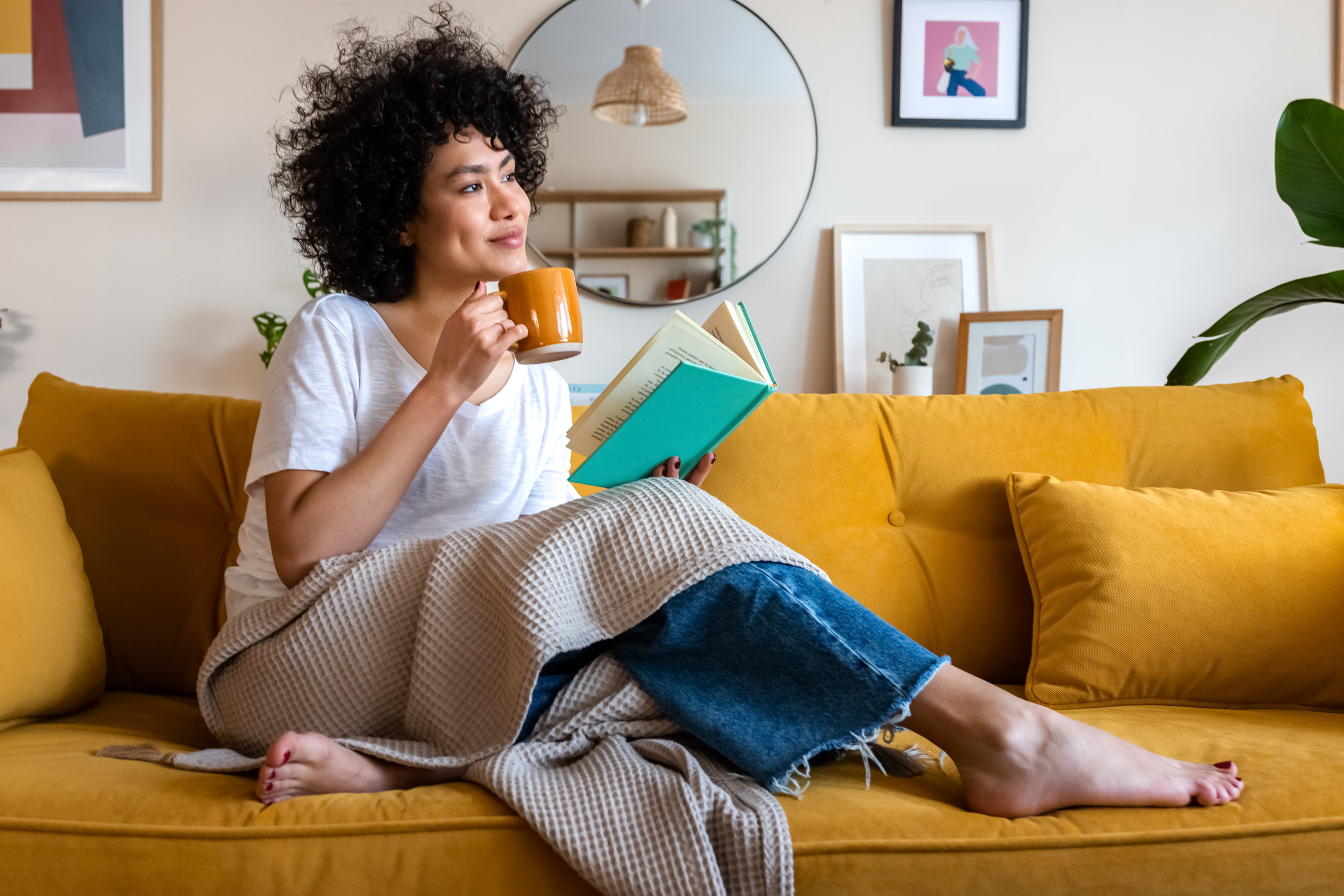 woman relaxing on a yellow couch