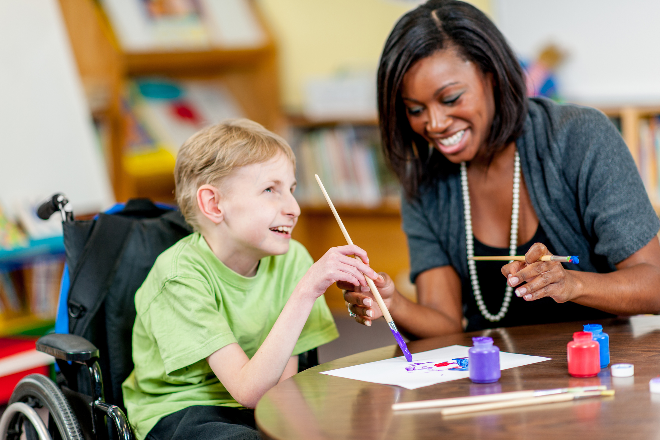 teacher working with student