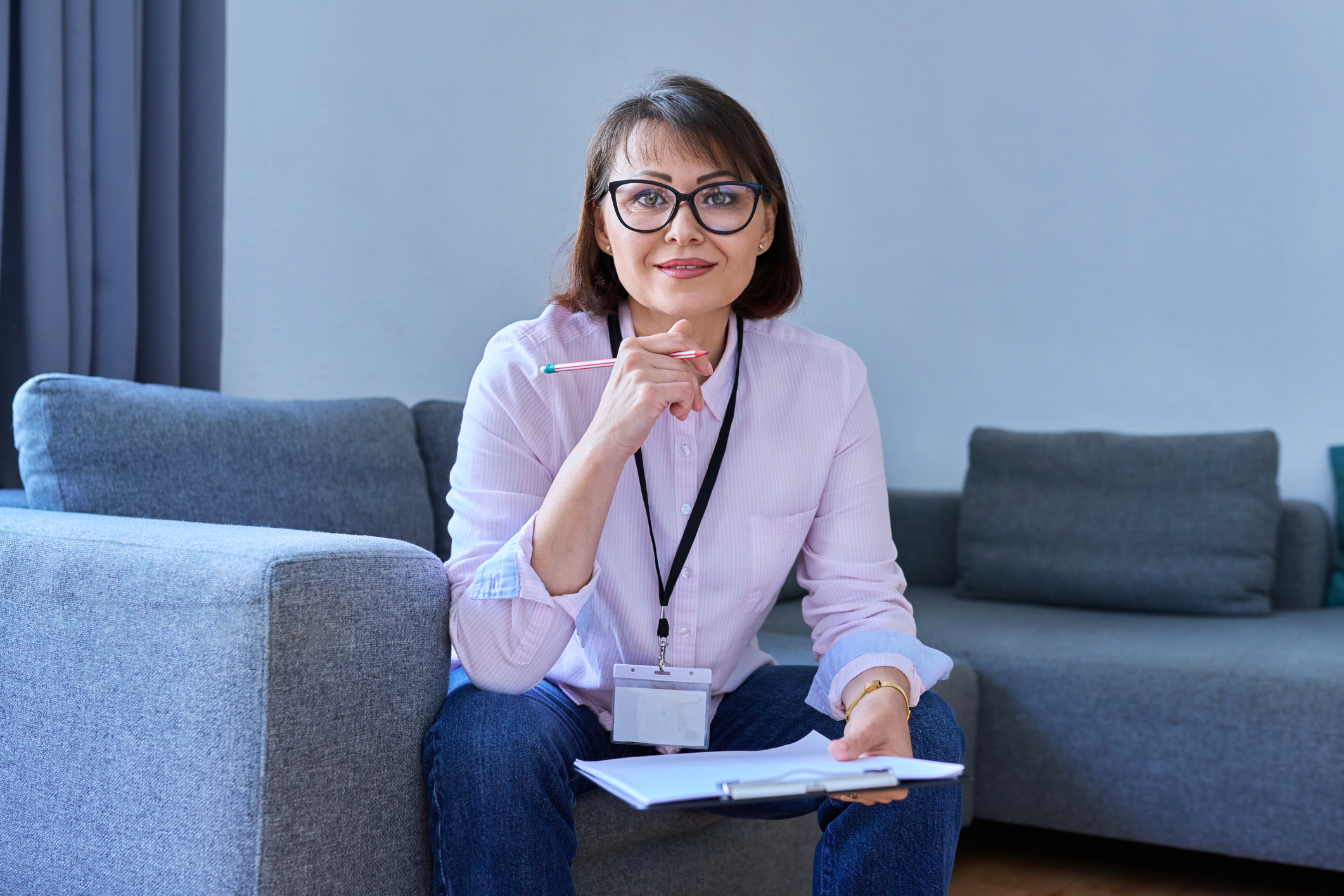 woman holding clipboard looking at camera