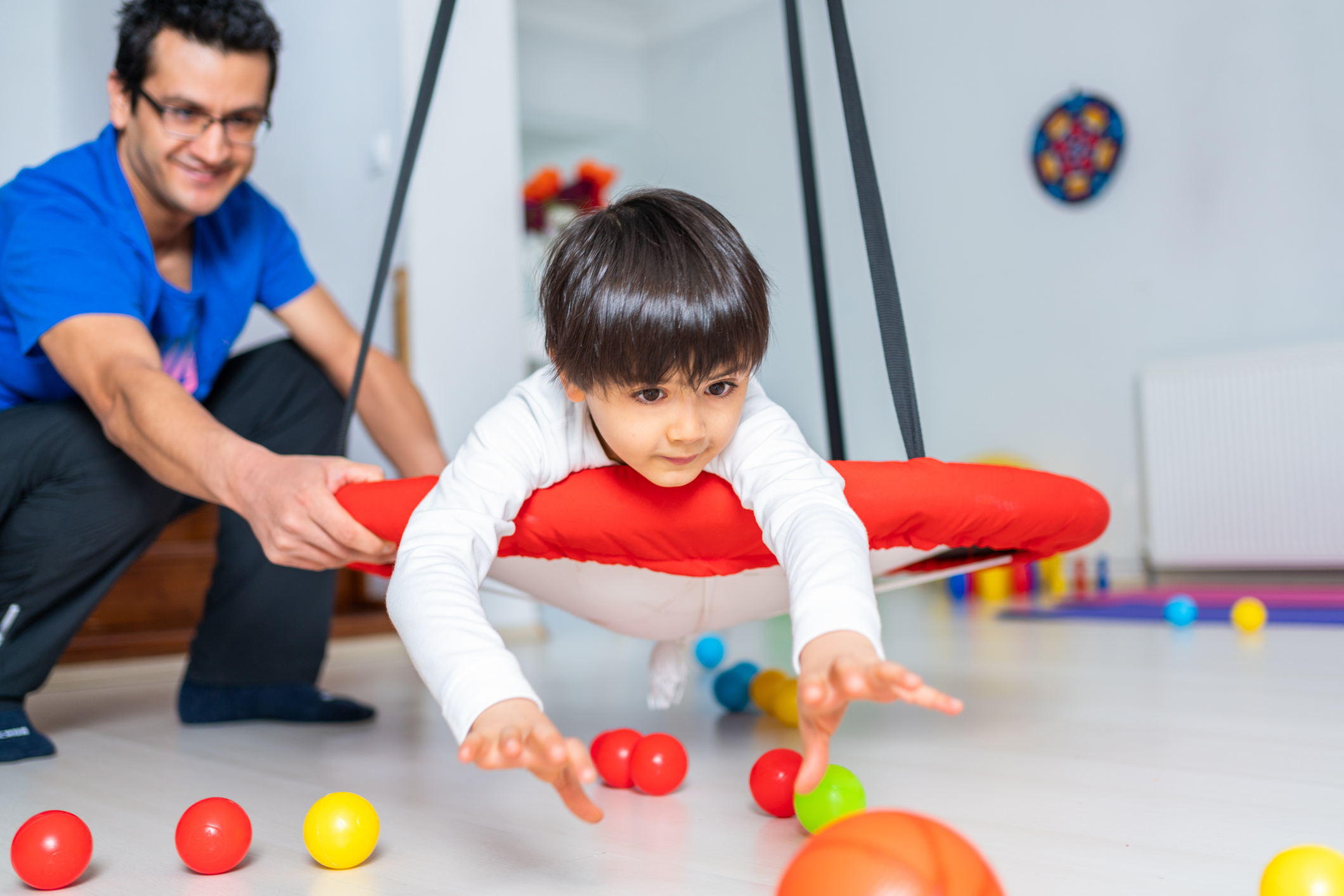 child playing with toys observed by therapist