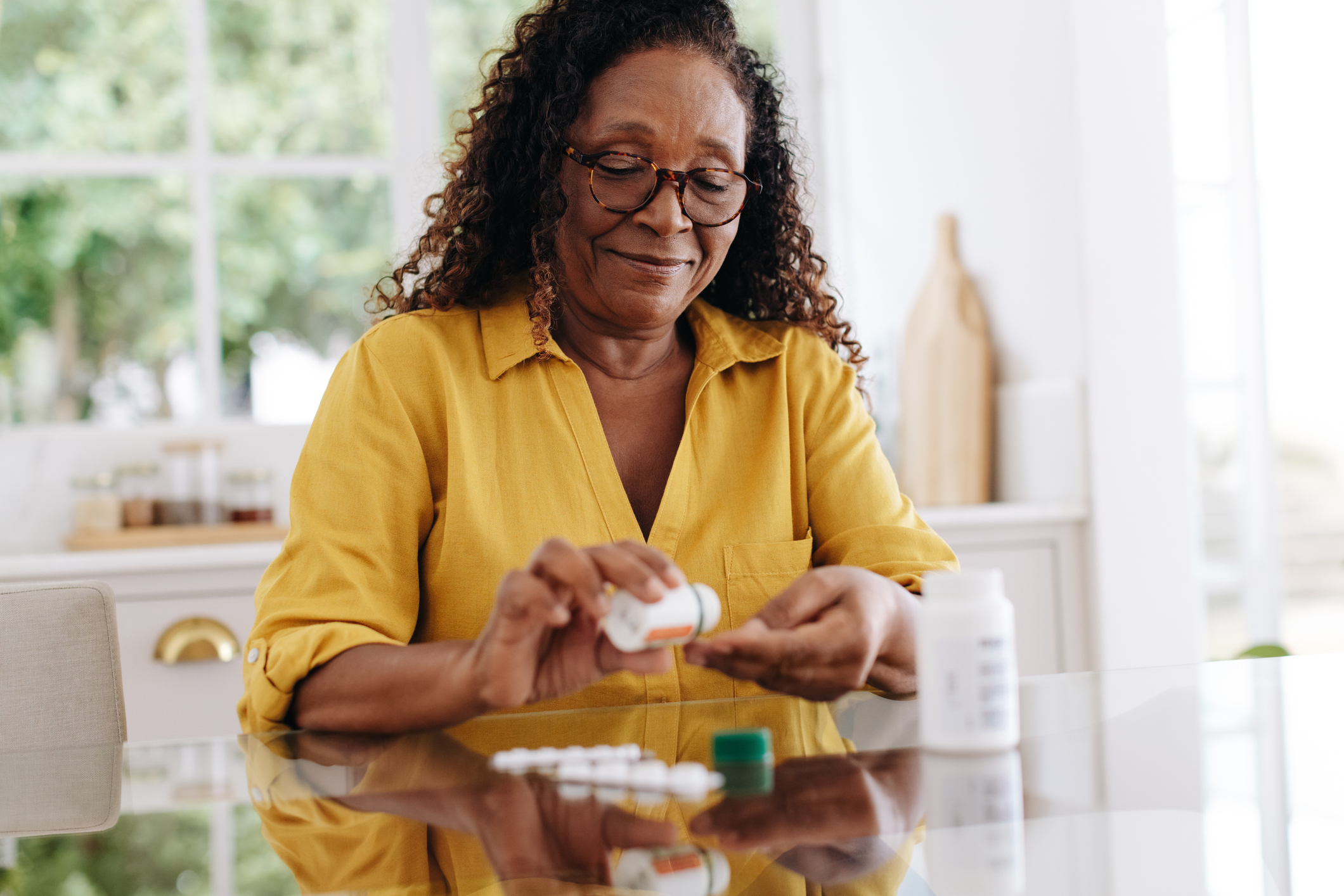 woman pouring pills into her hands