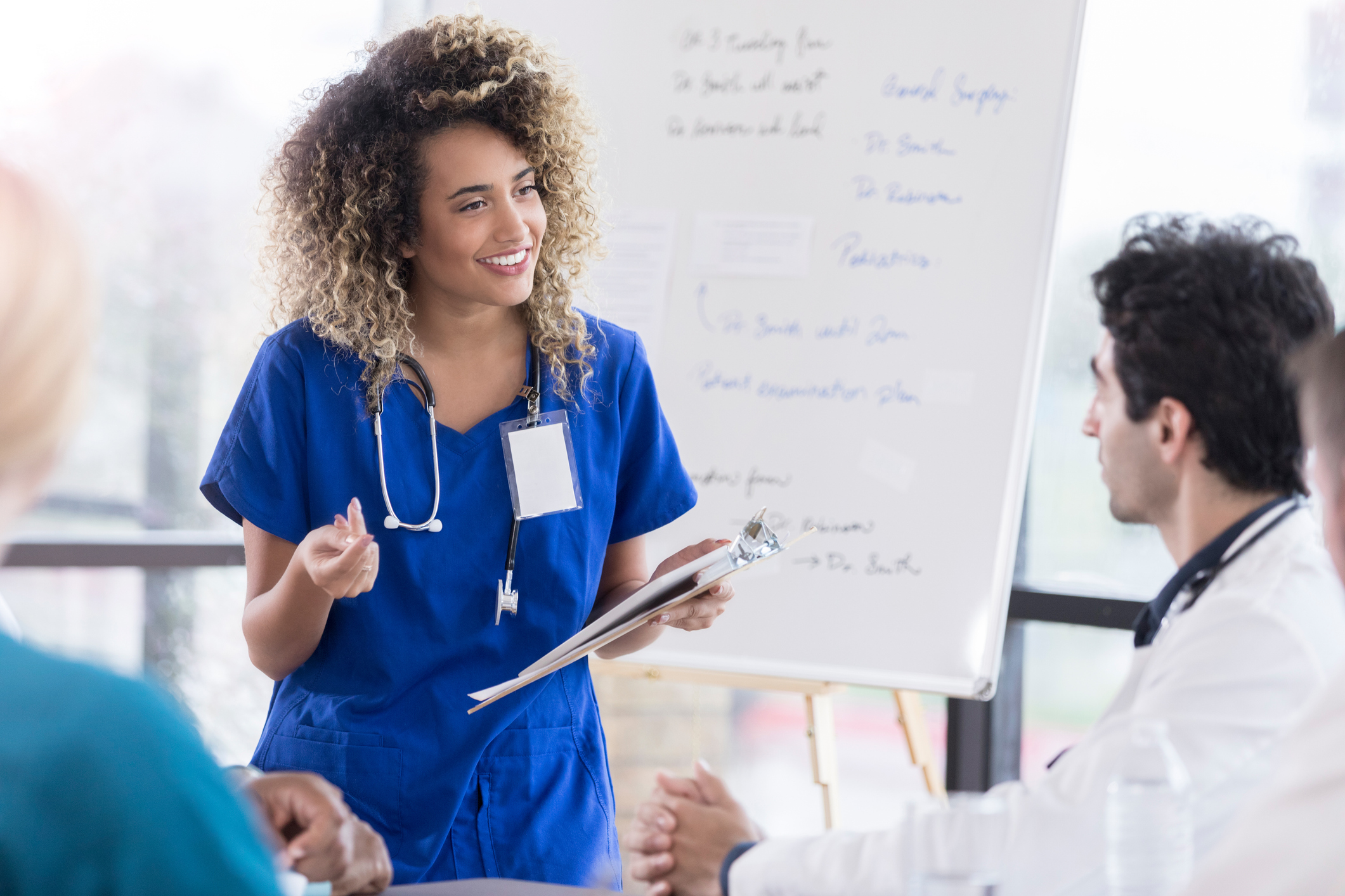 nurse talking to doctors