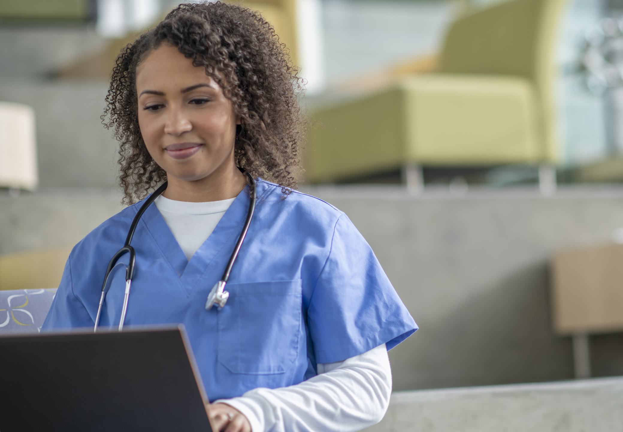 Nurse typing on laptop