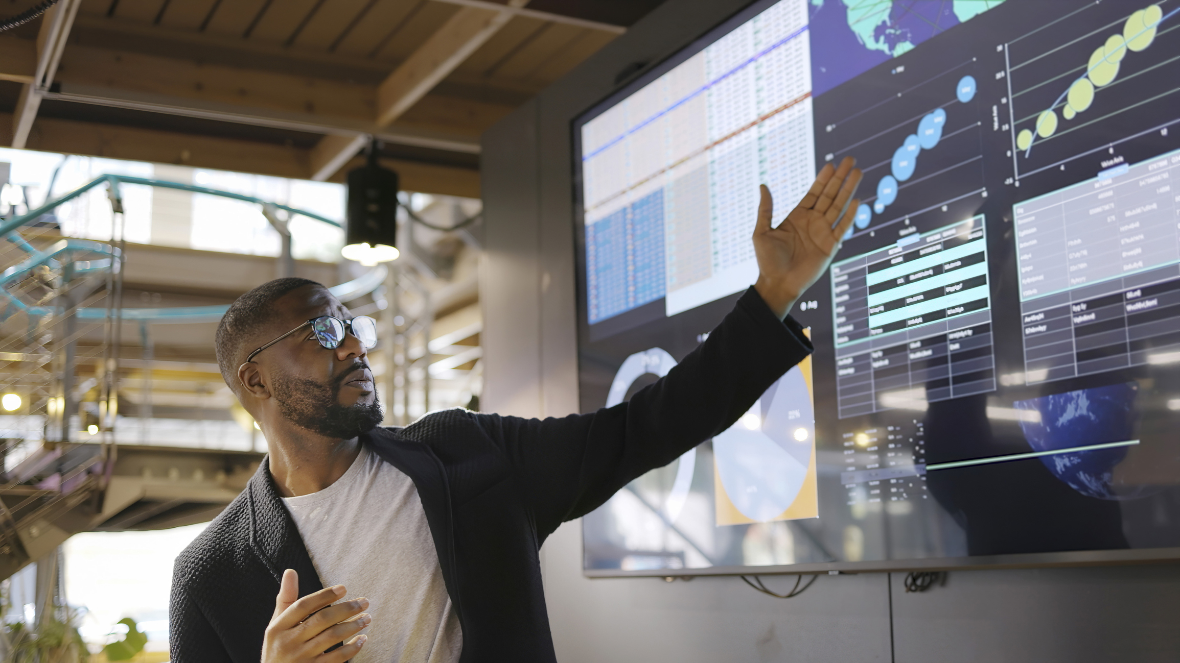 man presenting data on screen