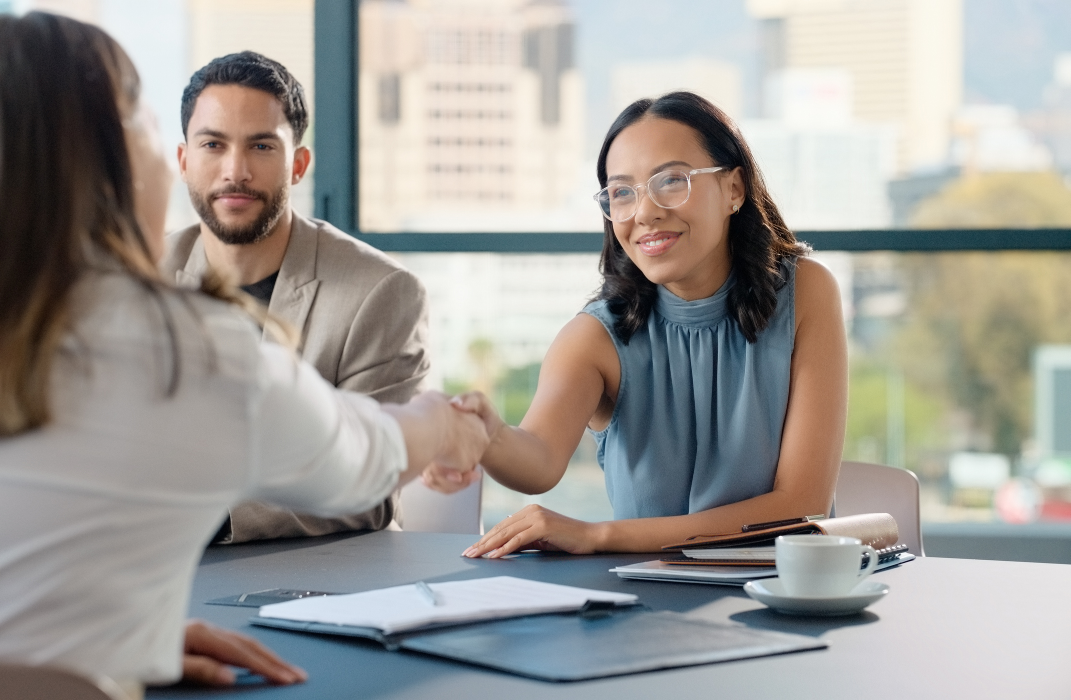 woman shaking hands with another woman