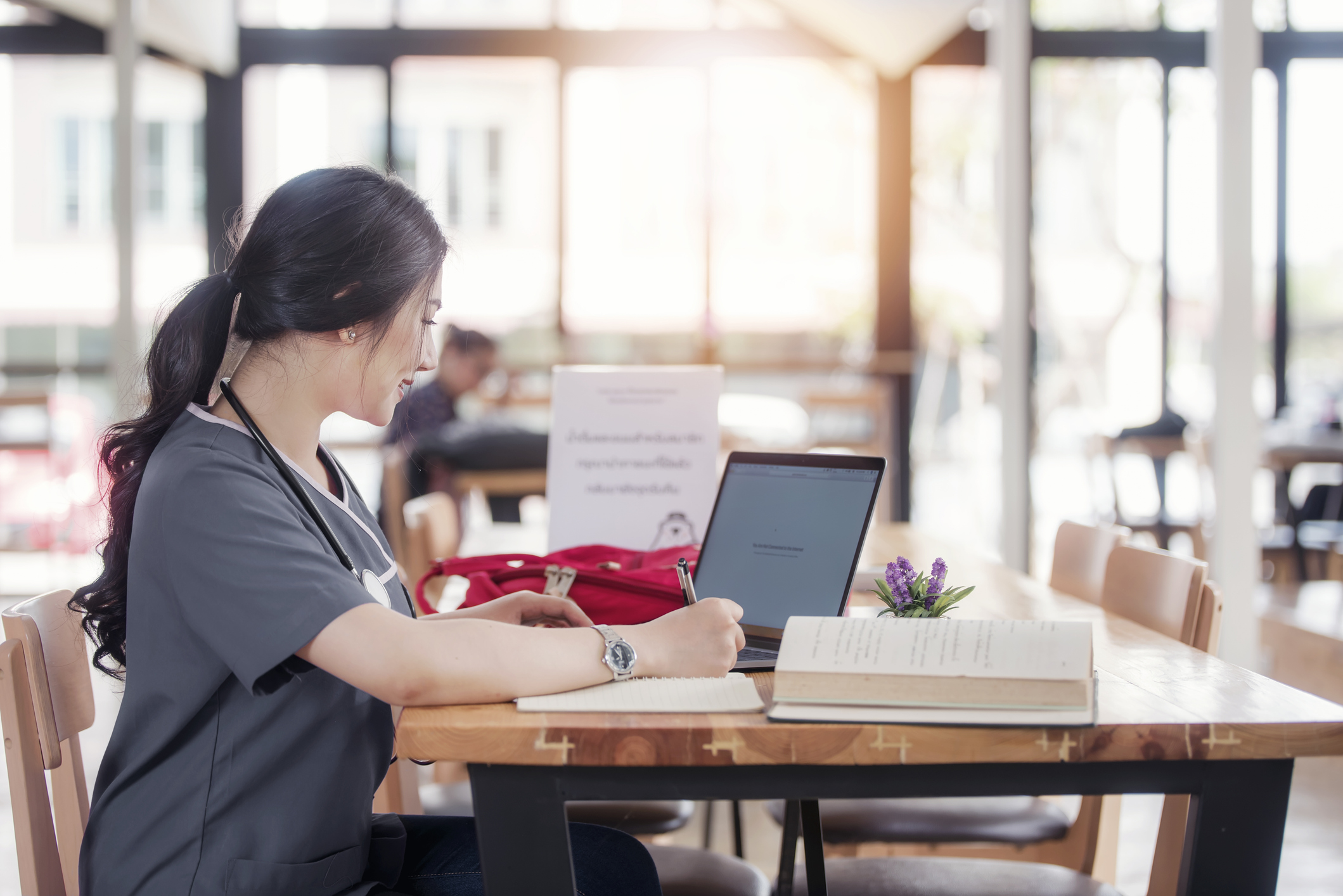 Nurse studying on laptop